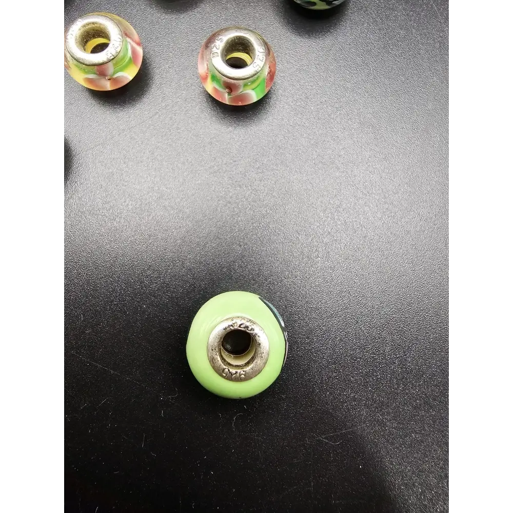 Green glass bead with silver metal core