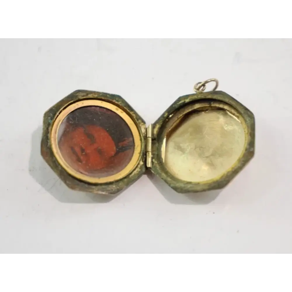 Hexagonal locket with a red stone