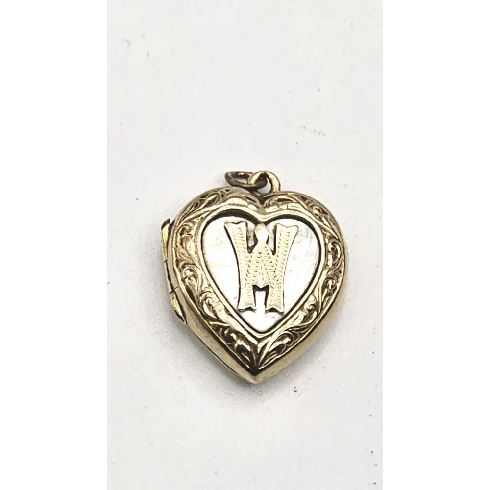 Heart-shaped locket with engraved design on a white background