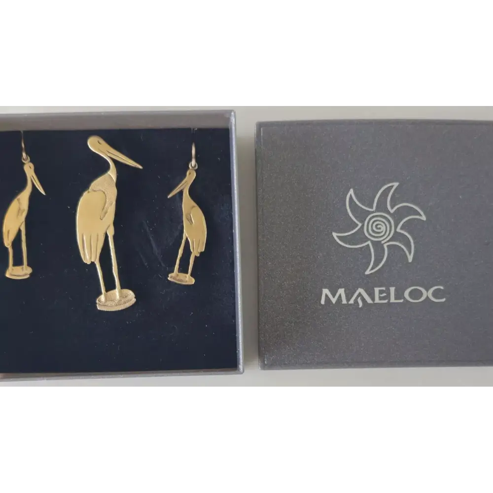 Gold bird-shaped earrings in a Maeloc branded box on a white background