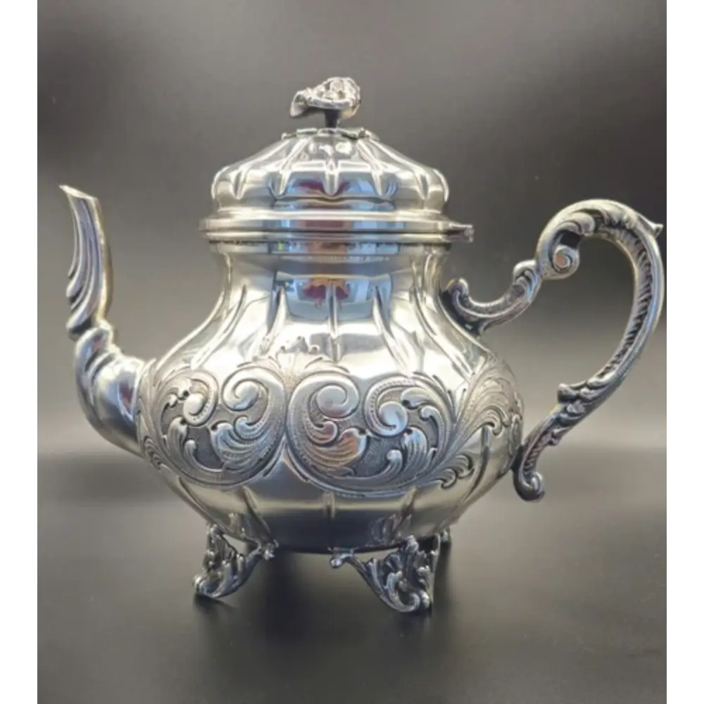 Close-up of intricate ornate designs on antique 800 silver tea pot