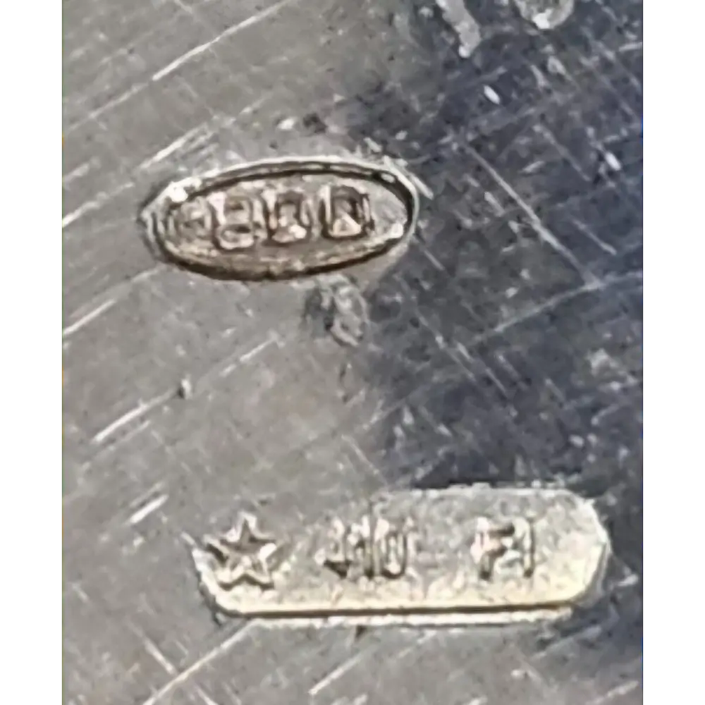 Close-up of metal surface with '925' stamp