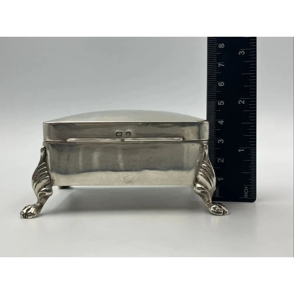 Silver jewelry box with paw feet on a white background