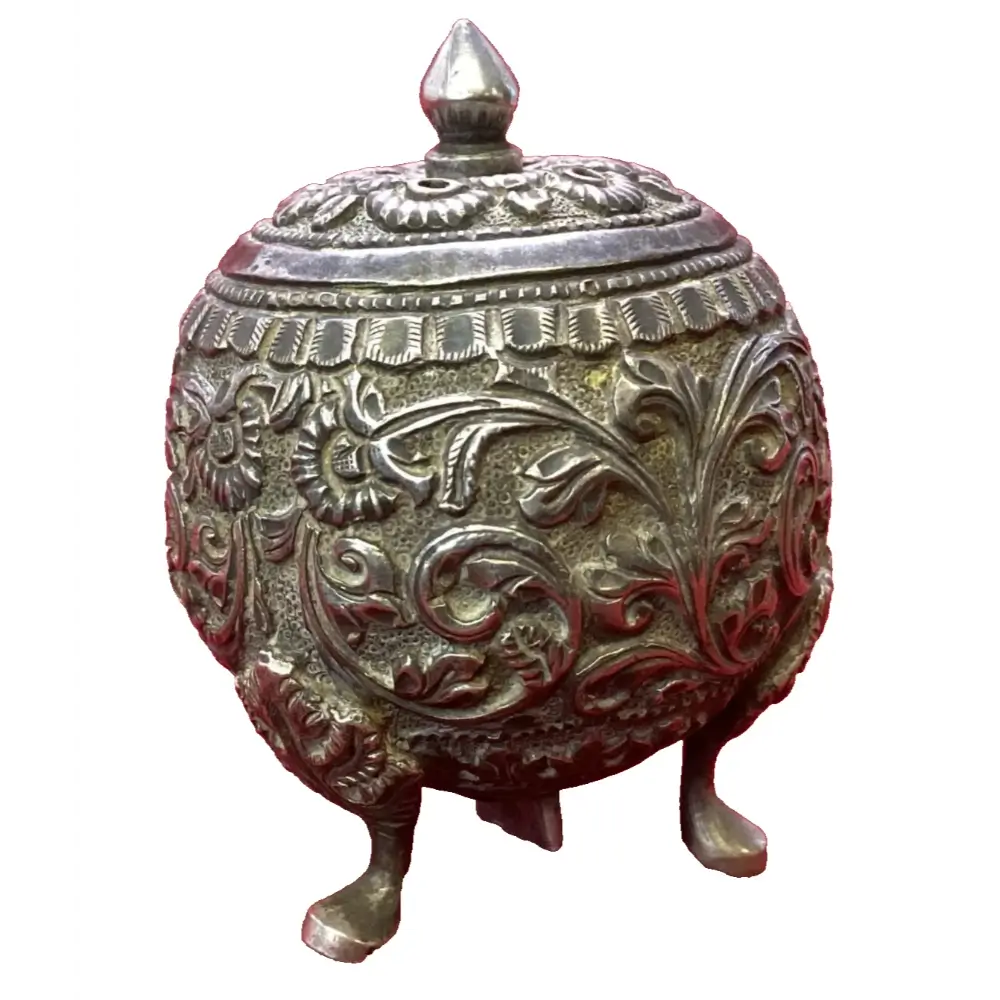 Decorative metal container with intricate designs on a white background