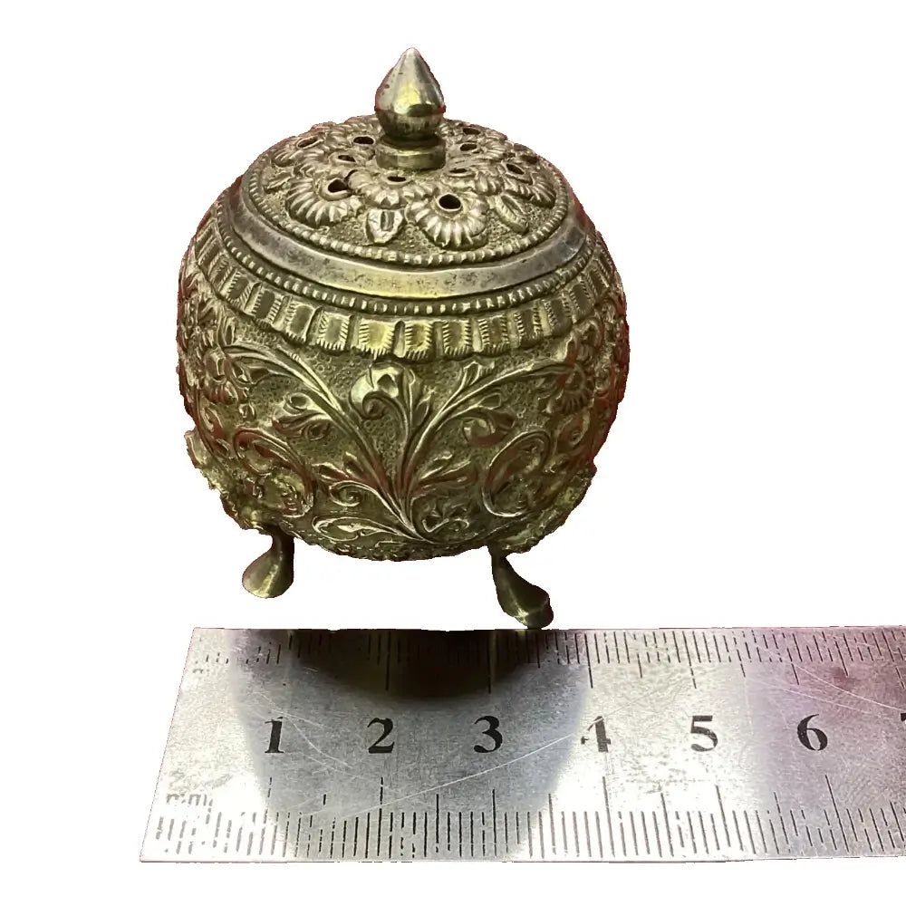 Decorative brass container with intricate designs