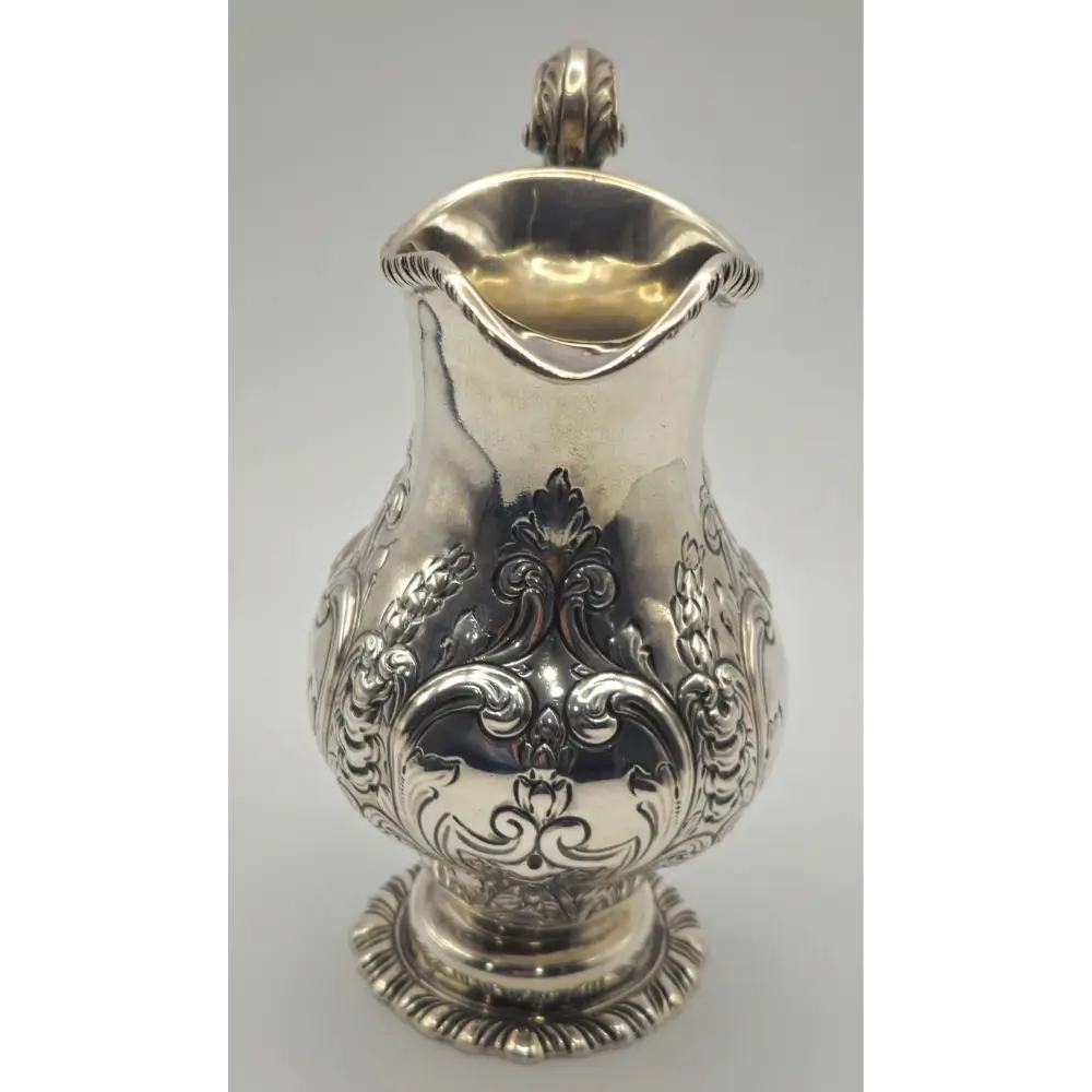 Silver pitcher with intricate designs