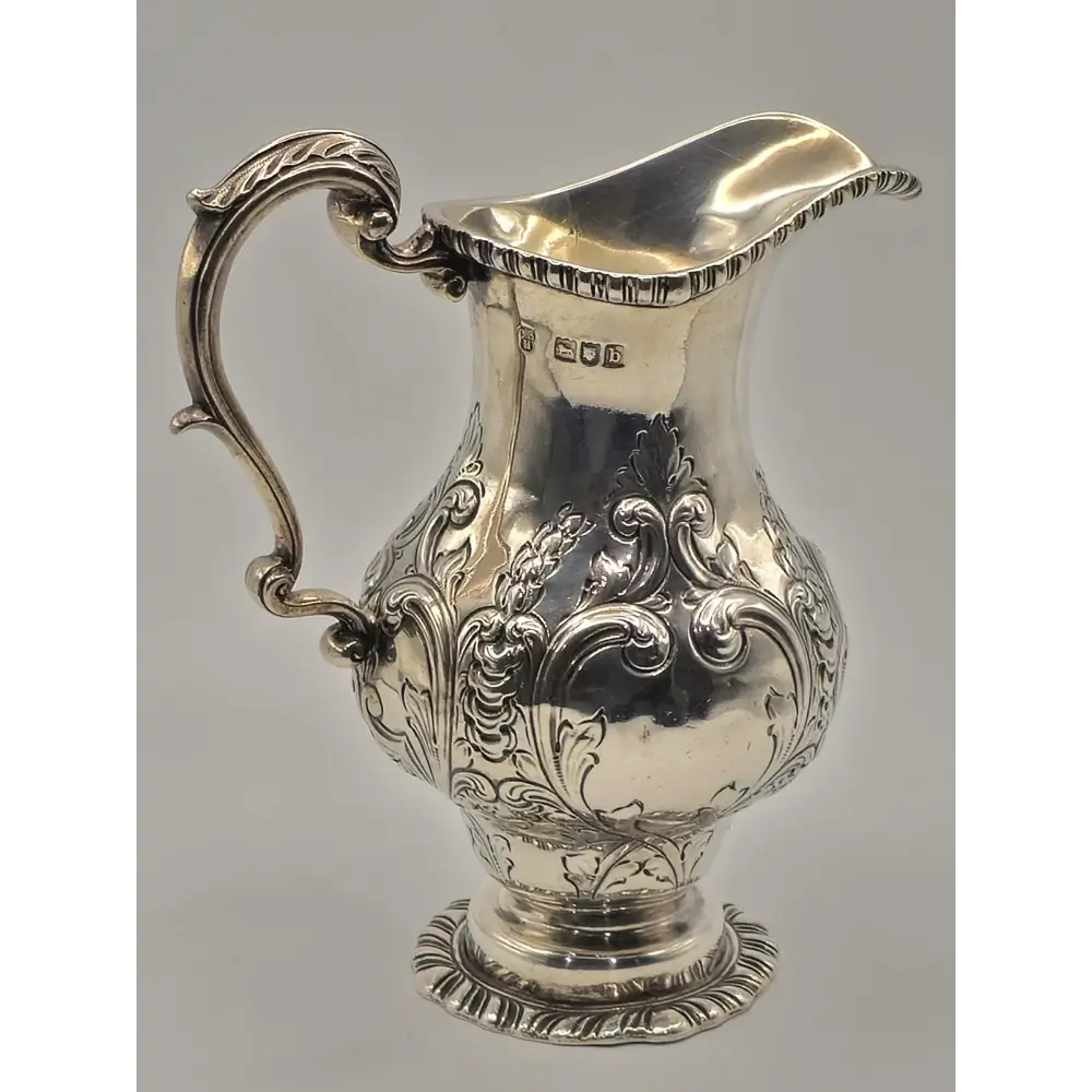 Silver pitcher with intricate designs