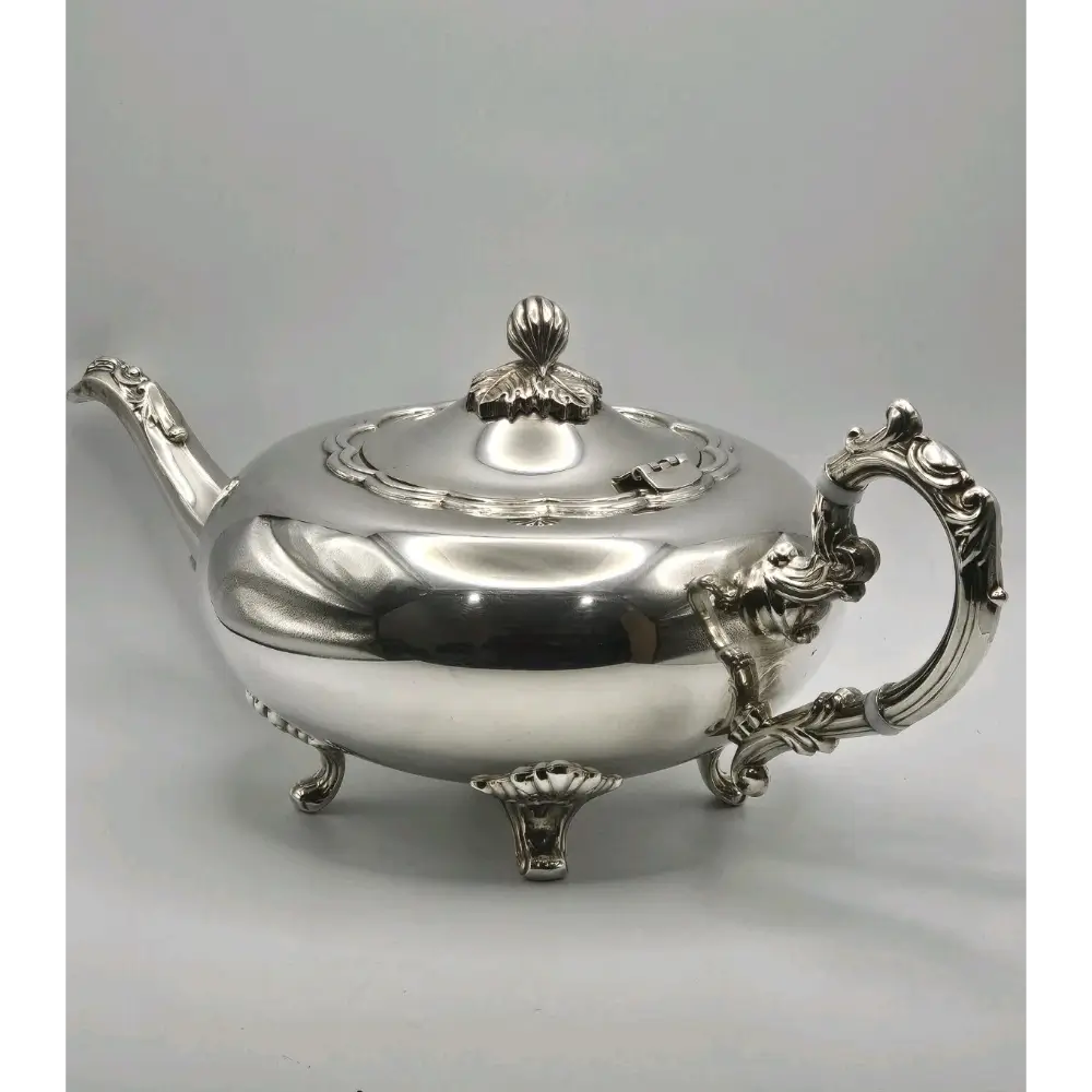 Silver teapot with ornate design