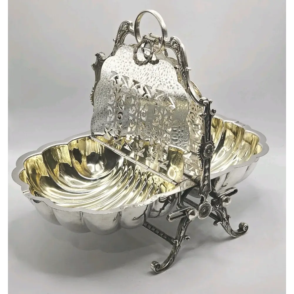 Decorative silver basket with intricate designs on a light gray background