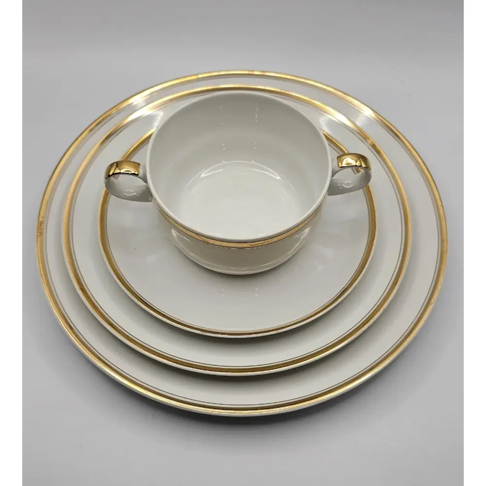 White cup with gold trim and matching saucer