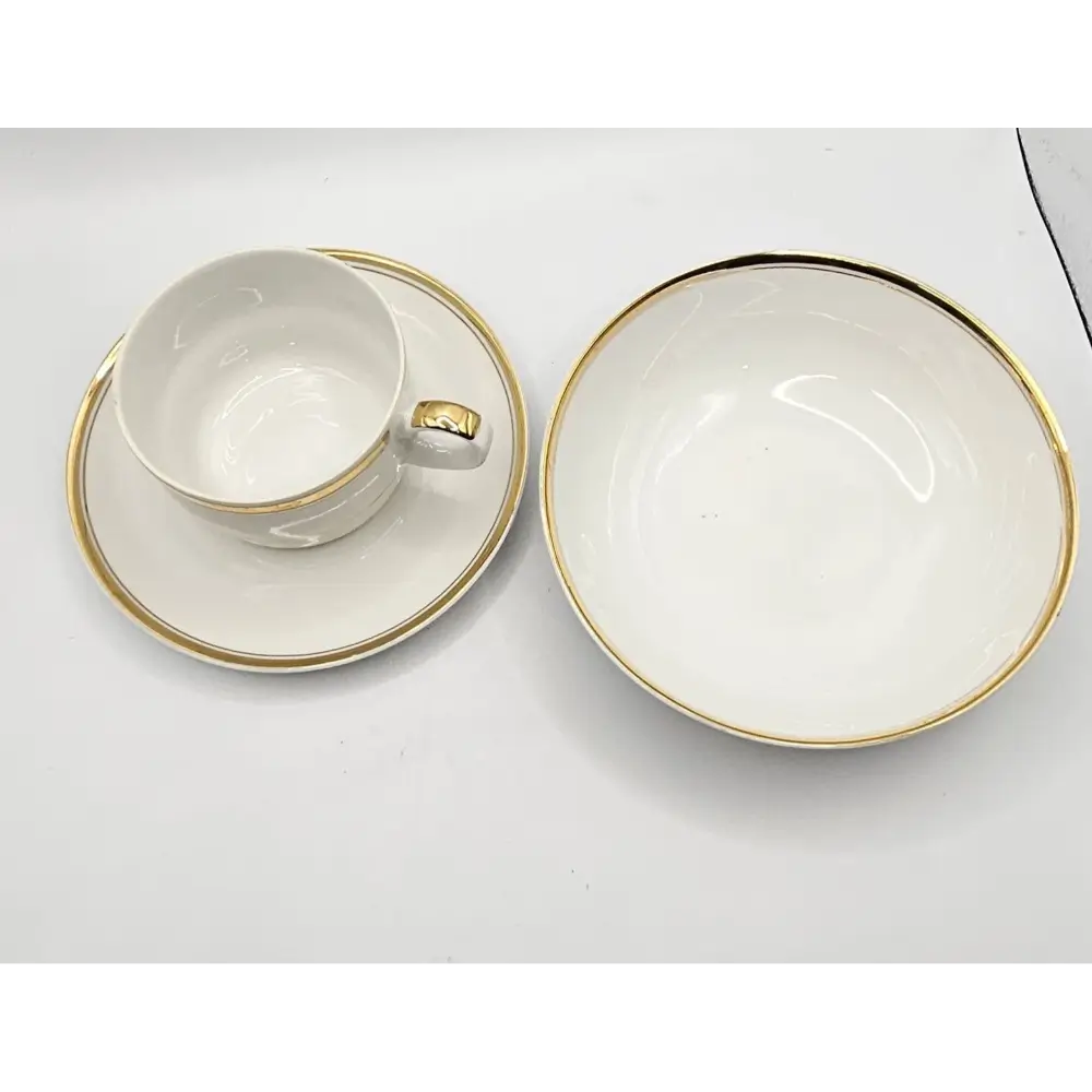 White ceramic cup and saucer with gold trim