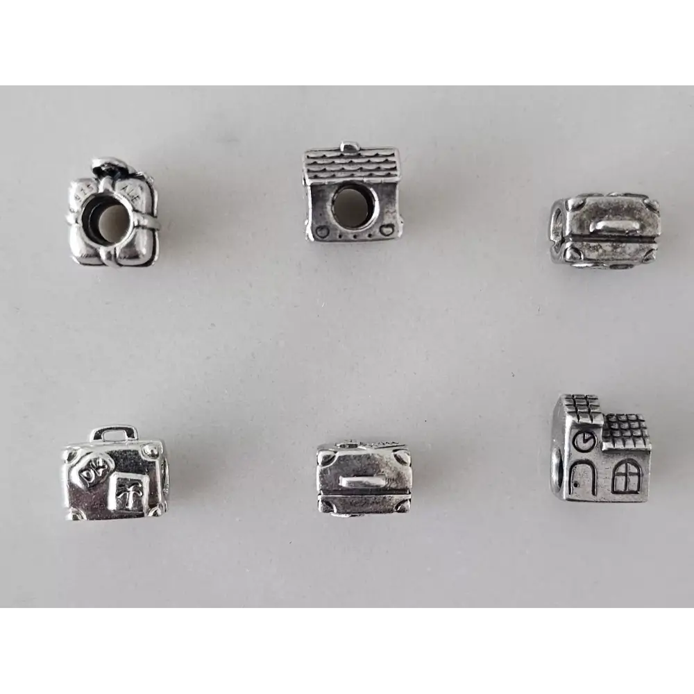 Set of silver charm beads on a white background