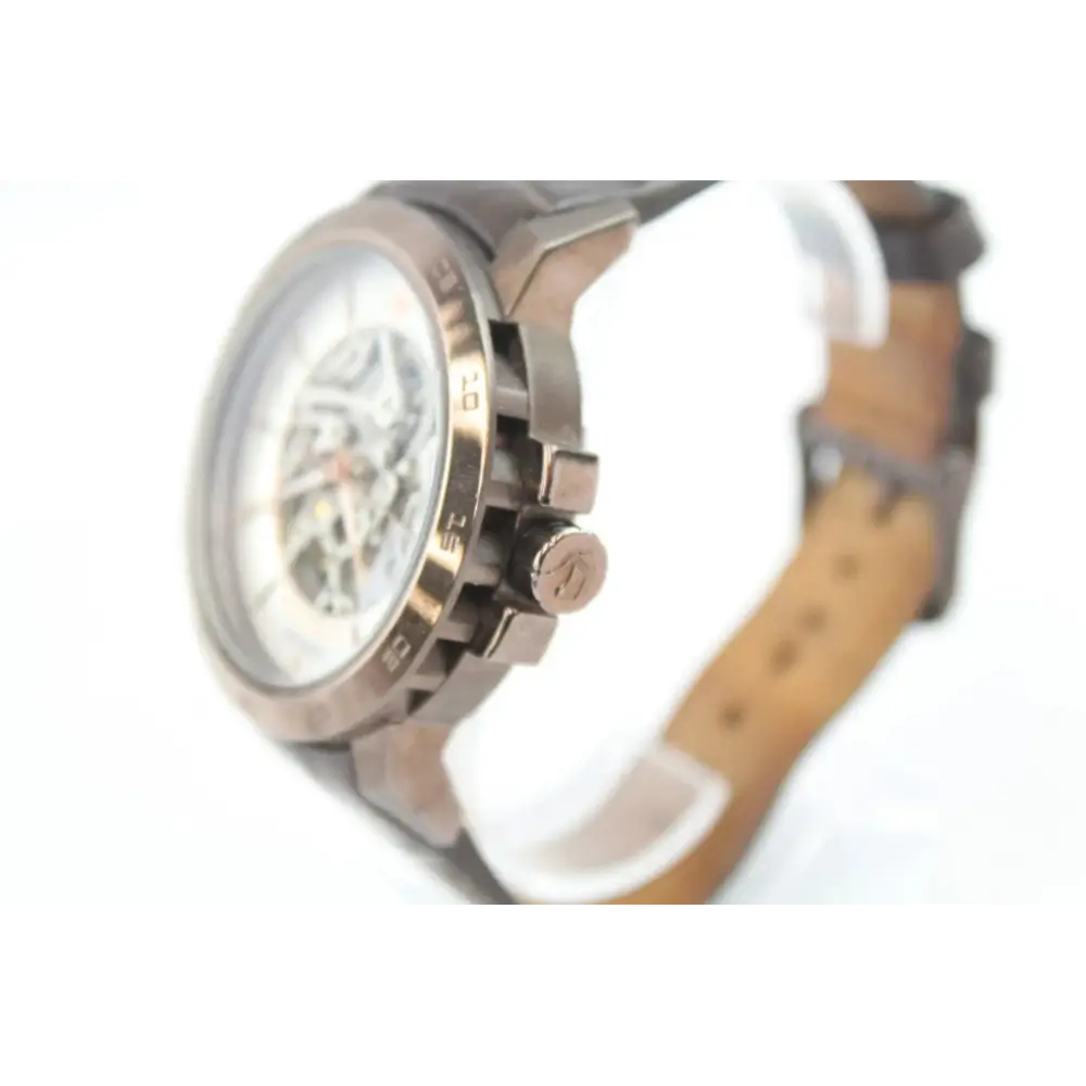 Close-up of a wristwatch with a brown leather strap