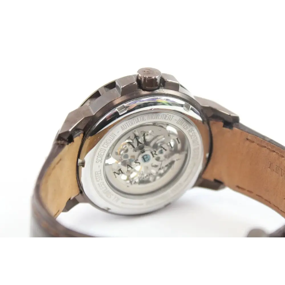 Close-up of a watch with a brown leather strap on a white background
