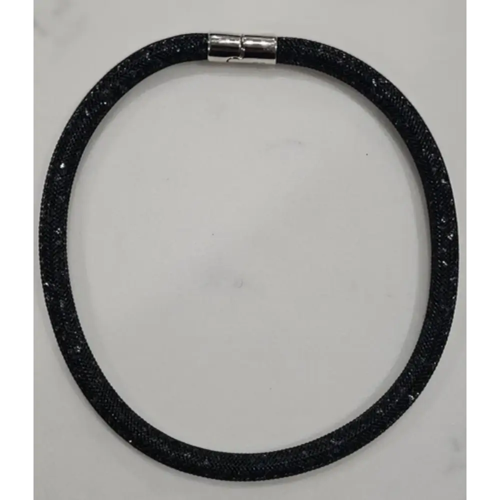 Black glittery choker necklace on a gray background