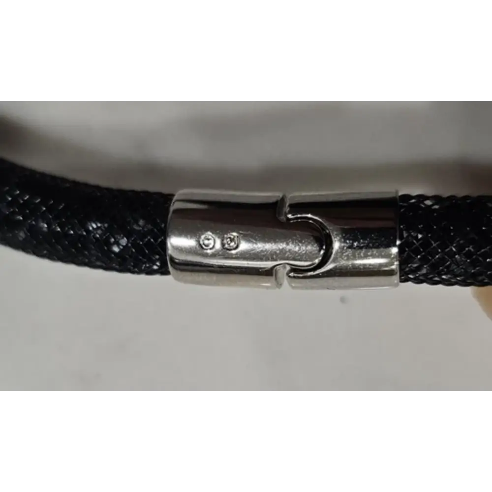 Close-up of a black braided cord with a silver clasp on a white background