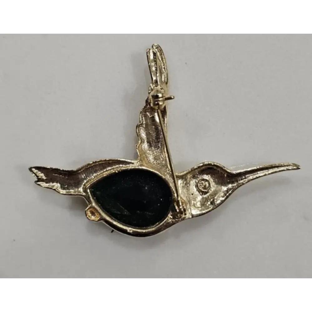 Gold hummingbird pendant with a black gemstone
