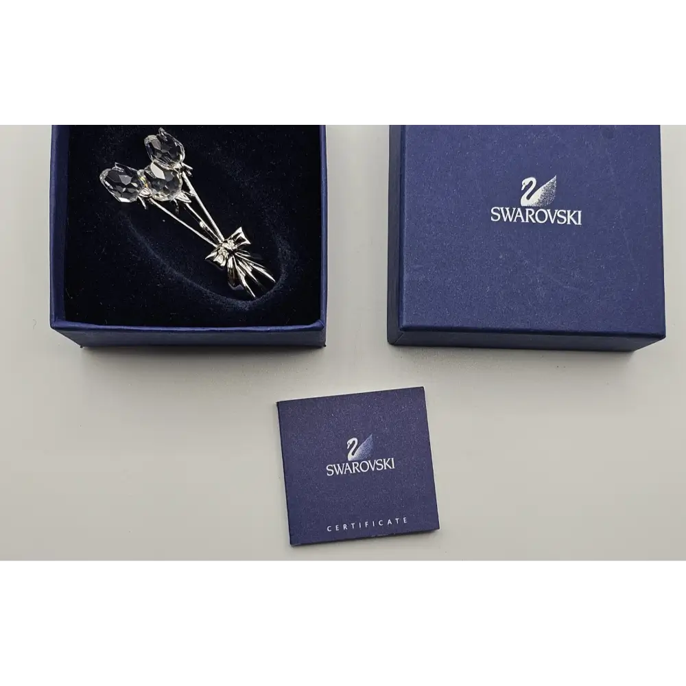 Swarovski crystal brooch in a box with a Swarovski certificate on a white background