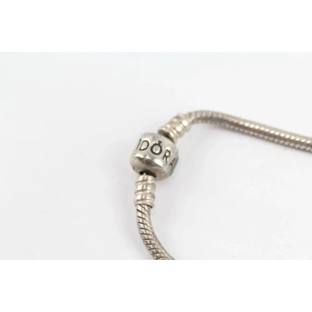 Silver bracelet with a close-up of a bead displaying 'DOR'