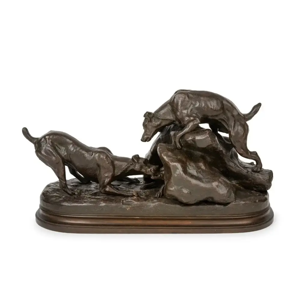 Bronze sculpture of three dogs on a white background