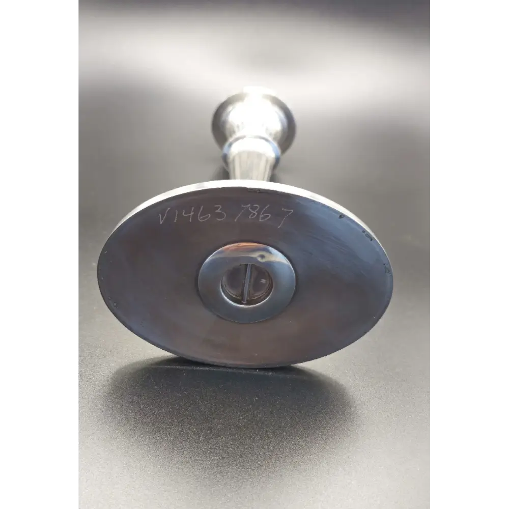 Metallic valve handle with visible serial number