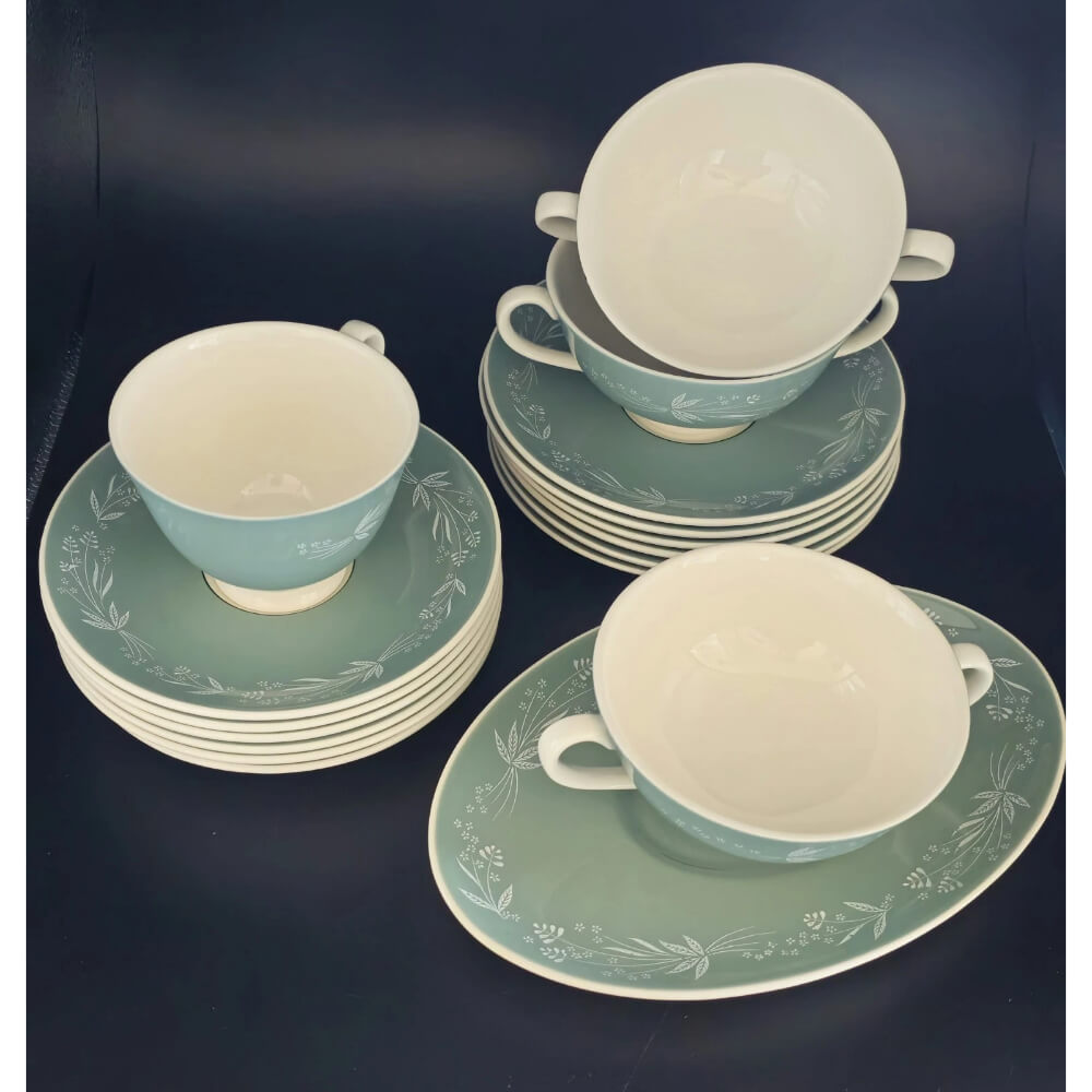 Ceramic tea set with green and white cups and saucers