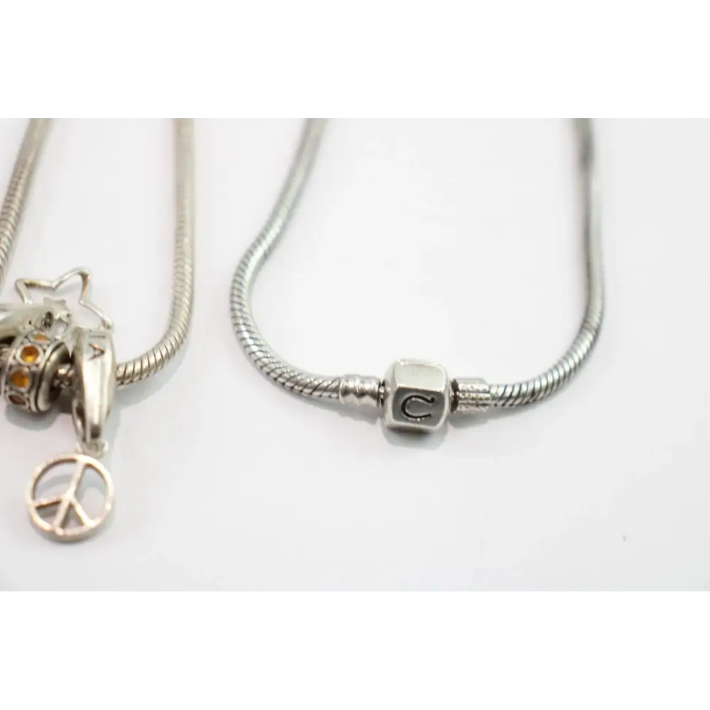 Silver necklace with a peace sign charm