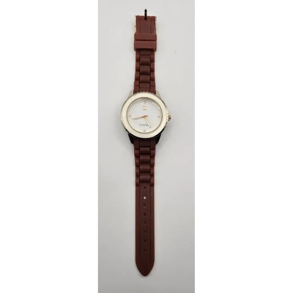 Watch with a brown strap on a light gray background