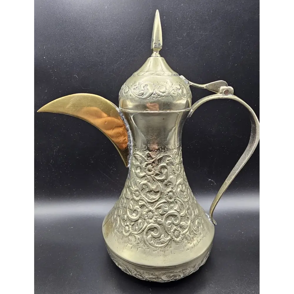 Decorative silver pitcher with intricate designs