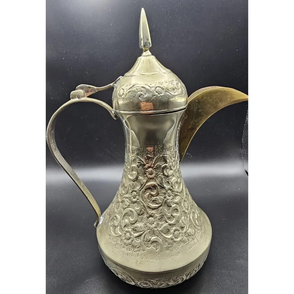 Decorative silver teapot with intricate patterns