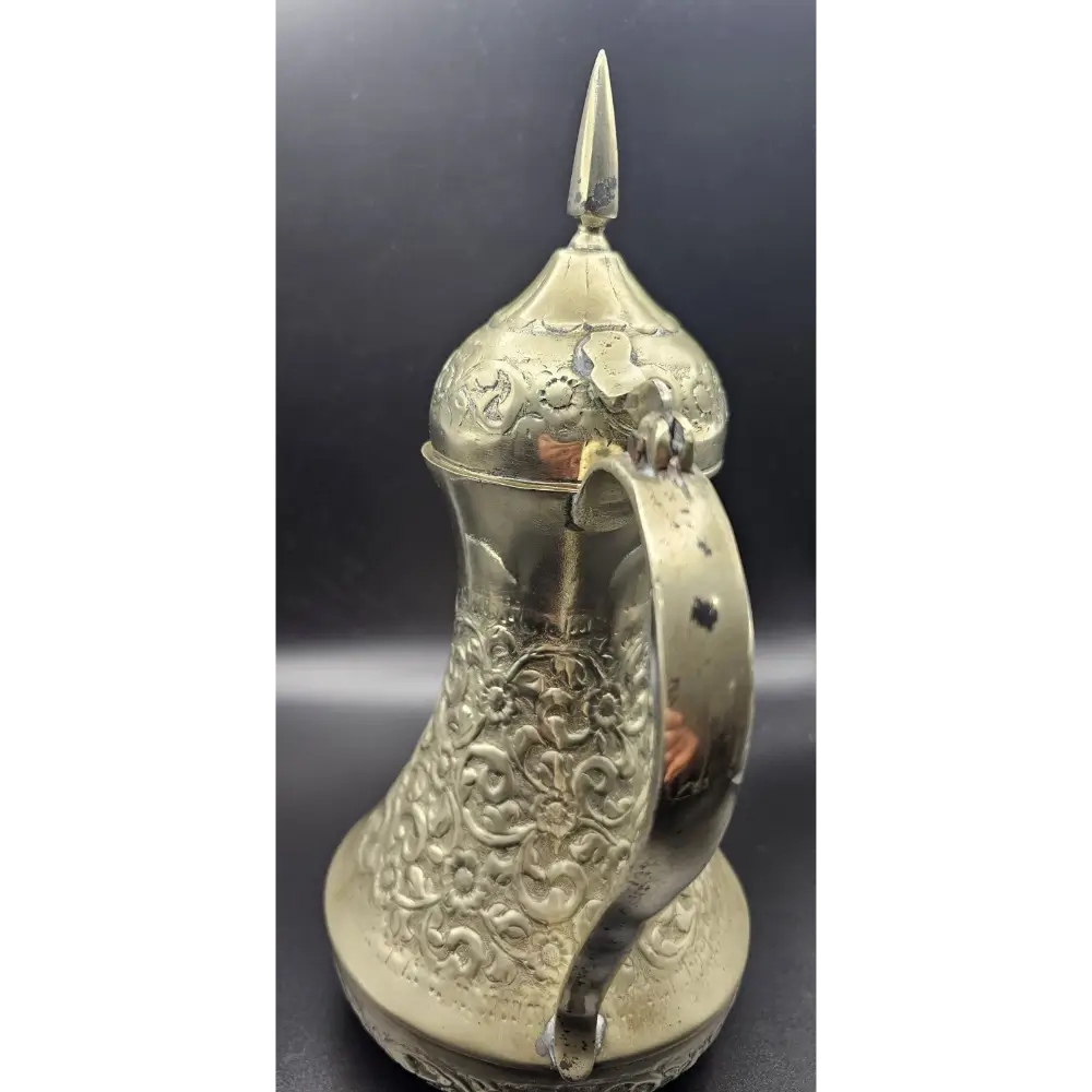 Decorative silver pitcher with intricate designs