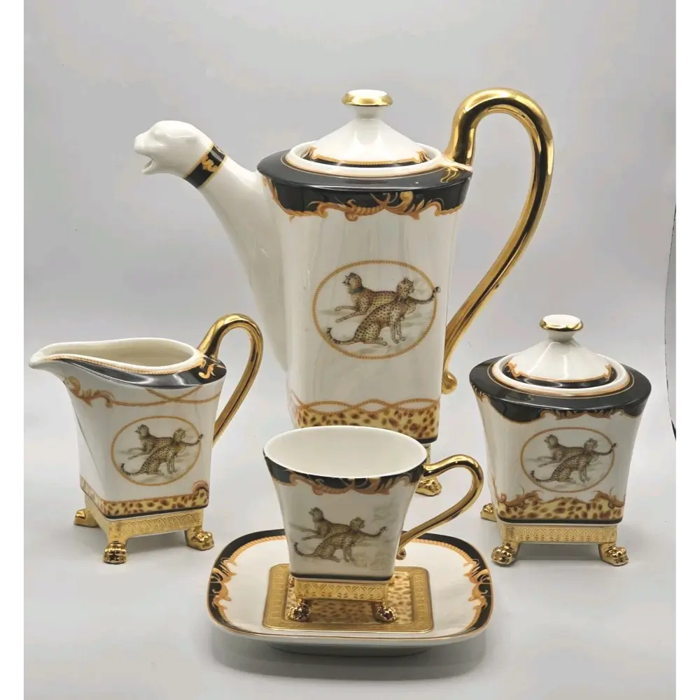 Ceramic tea set with white, black, and gold design