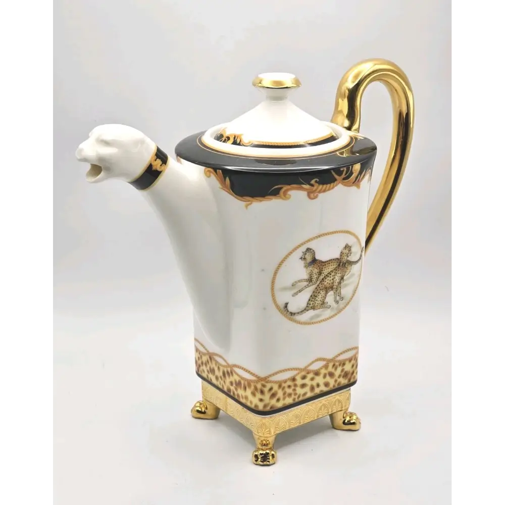 Decorative teapot with gold accents and animal illustrations