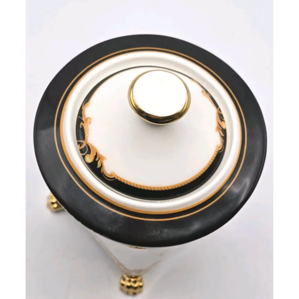 Decorative urn with black, gold, and white design