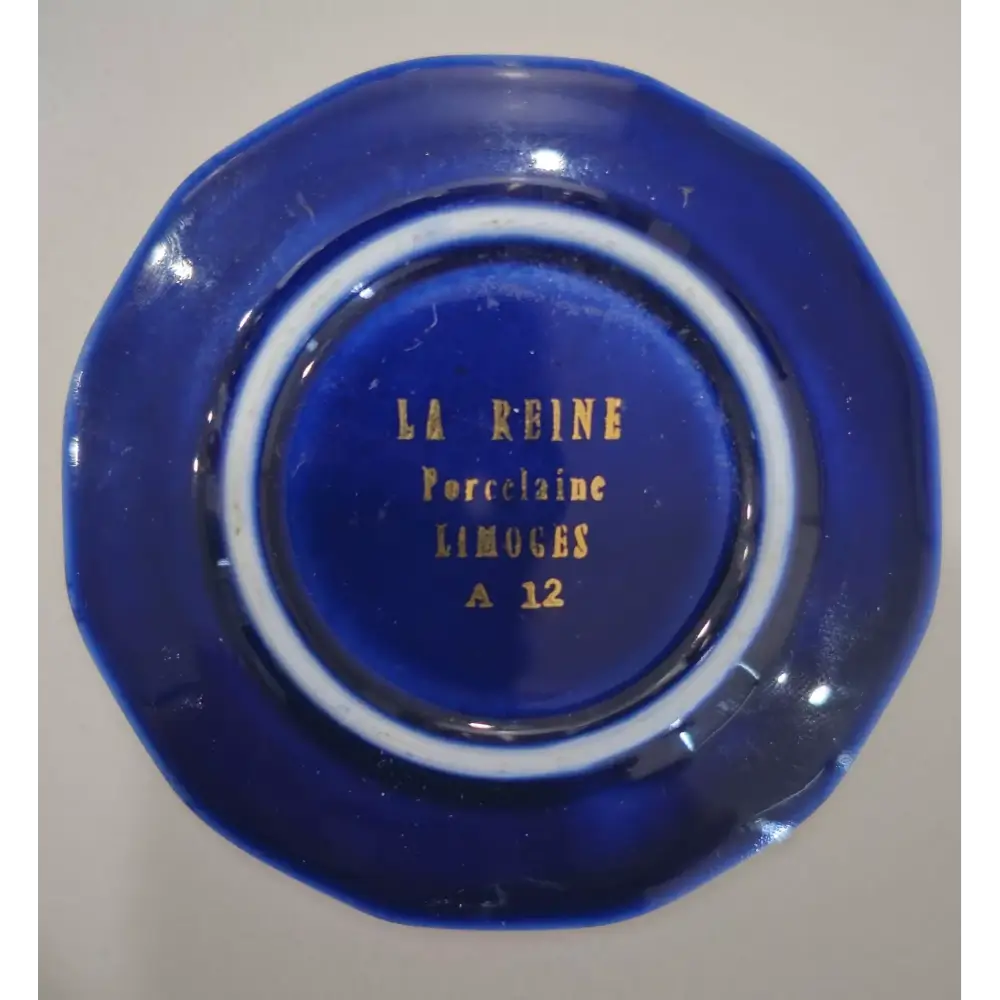 Blue ceramic dish with 'La Reine Porcelaine Limoges' branding