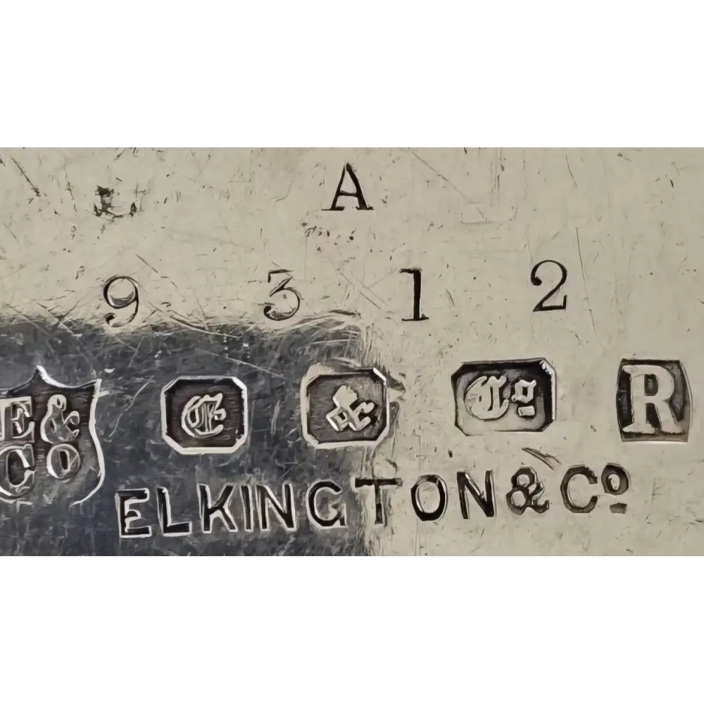Close-up of metal surface with 'Elkington & Co' branding and numbers.