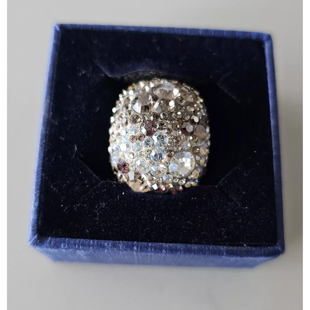 Silver ring with gemstones in a blue velvet box