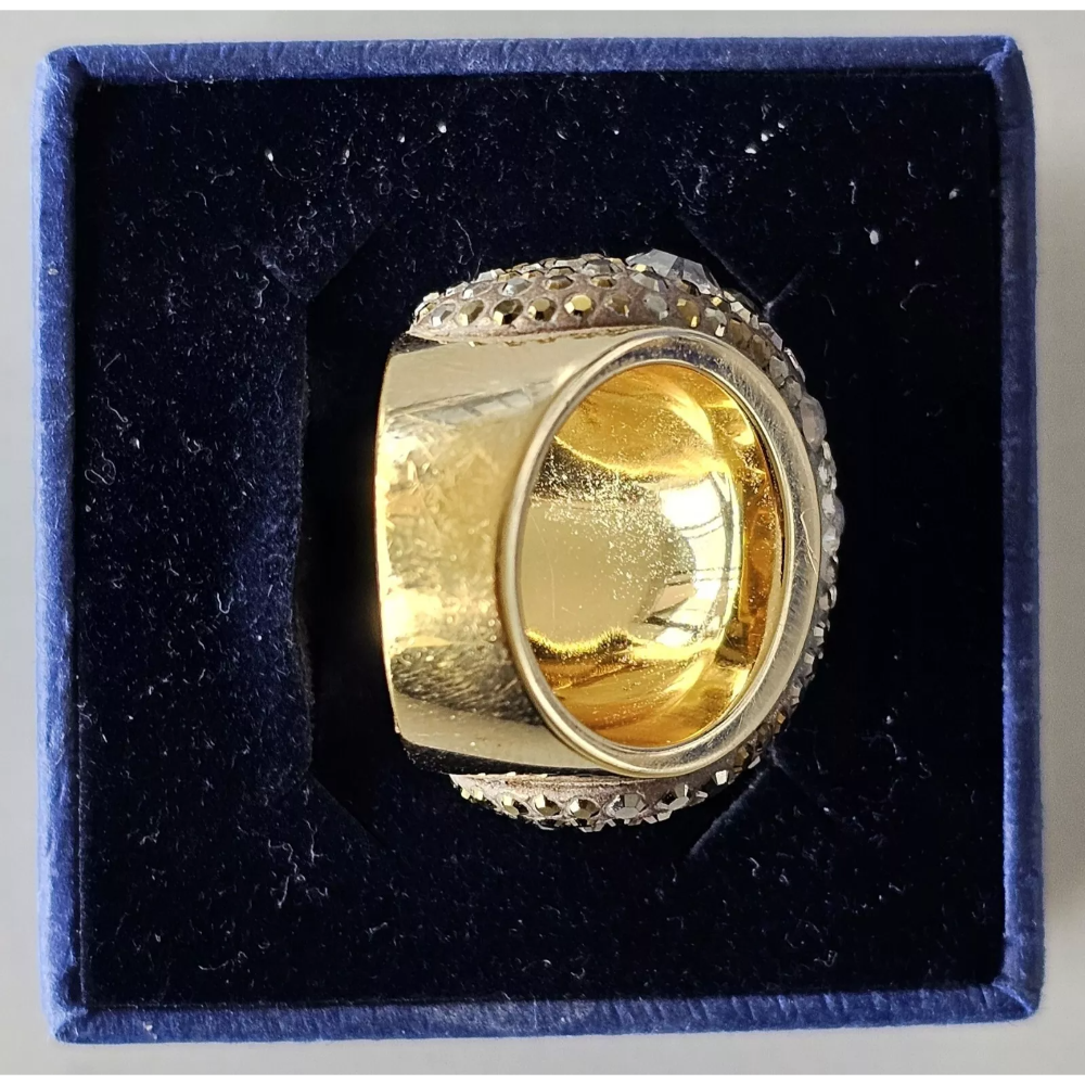 Gold ring with diamond accents in a blue box