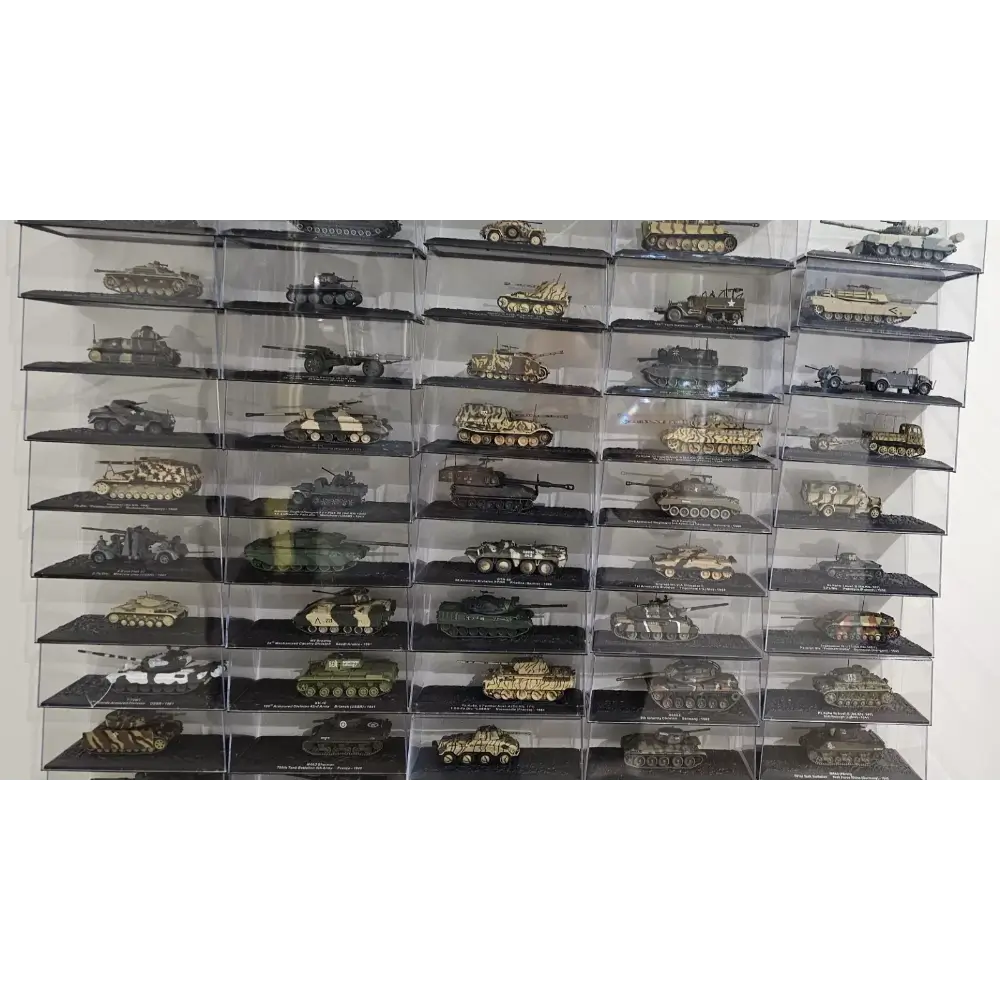 Collection of model tanks in clear display cases on a white background