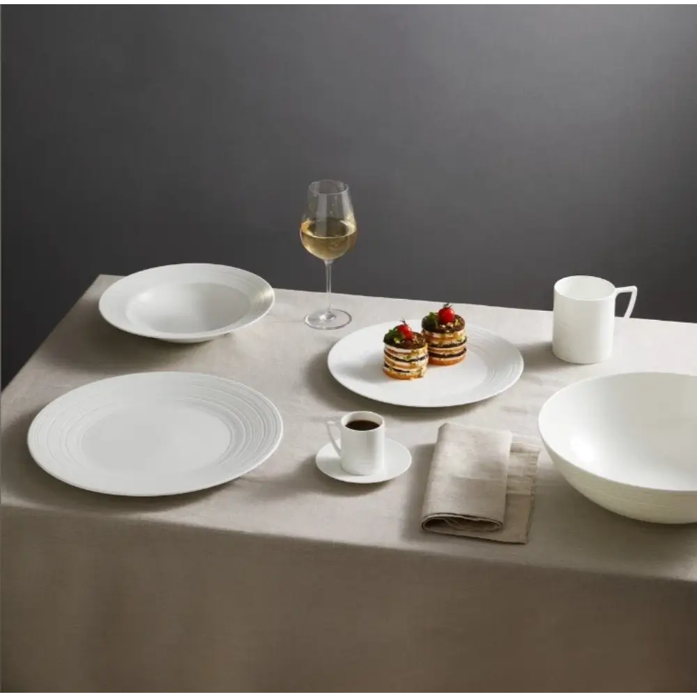 Dining table setting with white plates