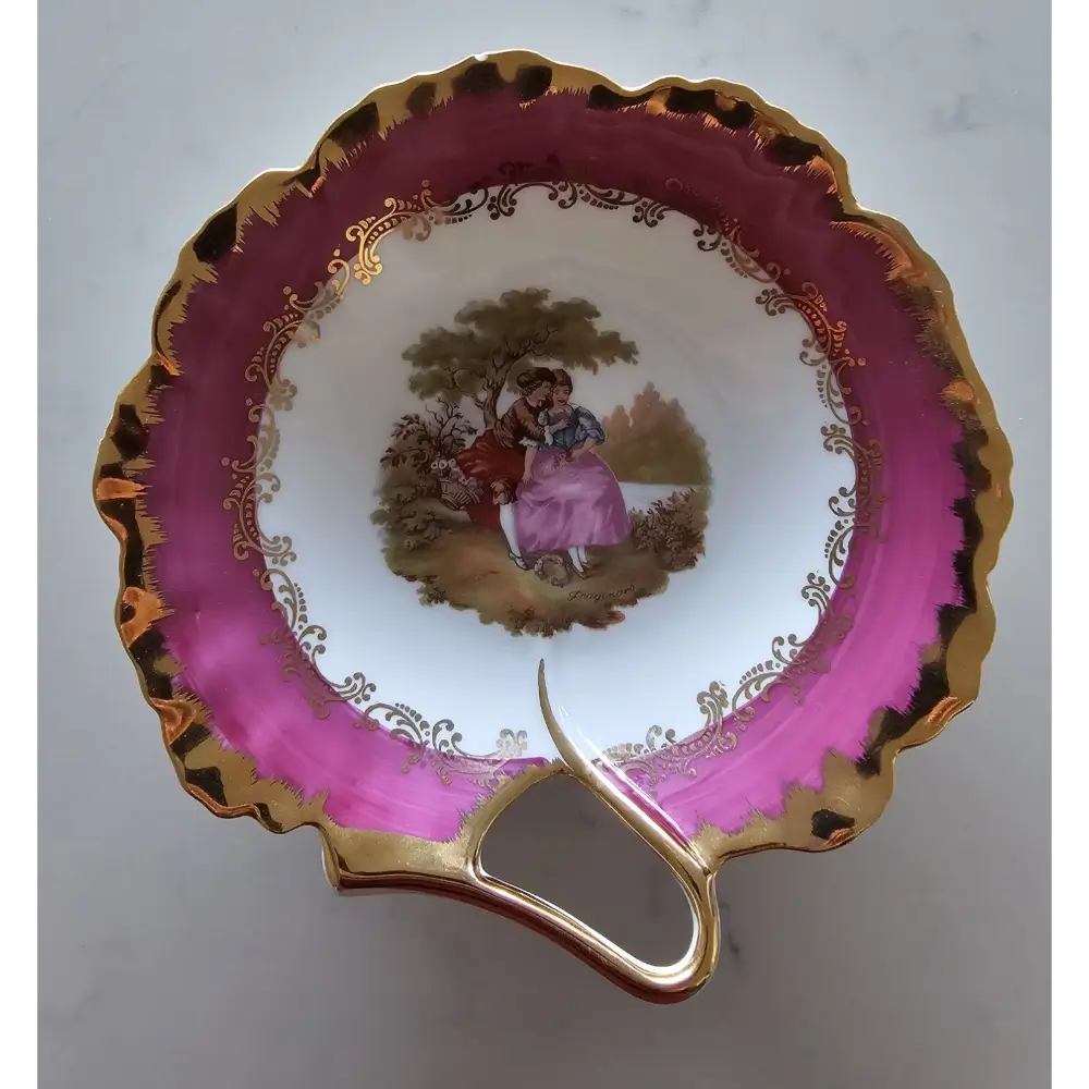 Vintage teacup with pink rim and gold handle