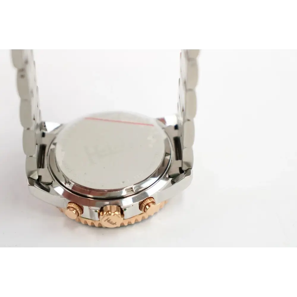 Close-up of a watch case with gold and silver accents