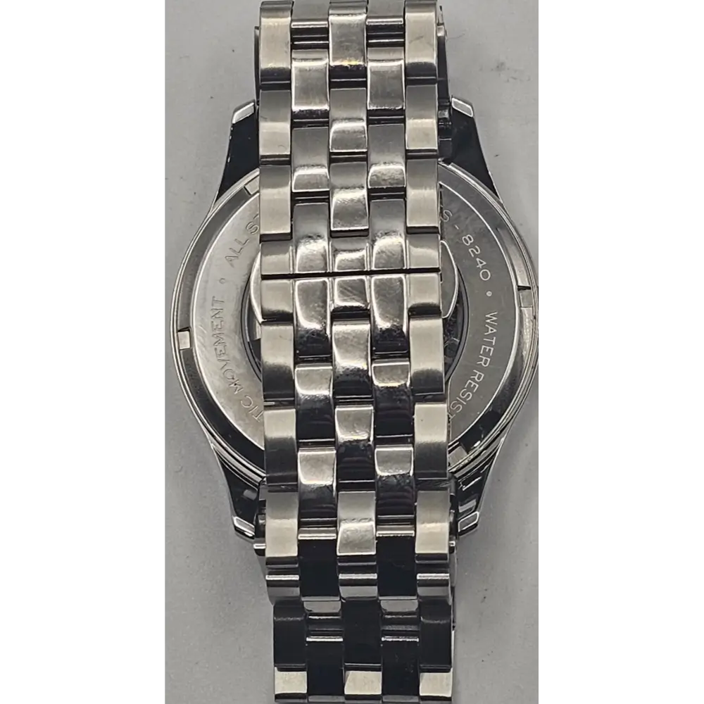 Silver watch with a detailed metal bracelet on a gray background