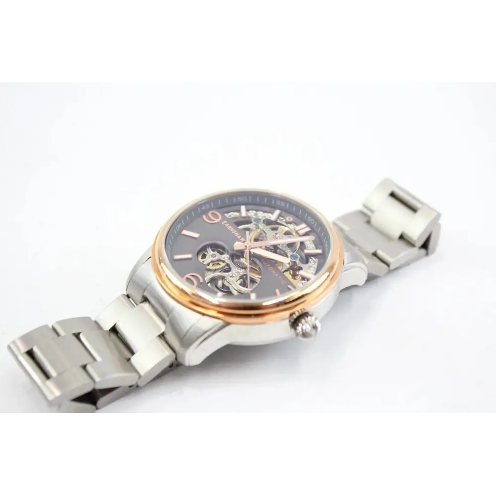 Silver watch with a detailed face on a white background