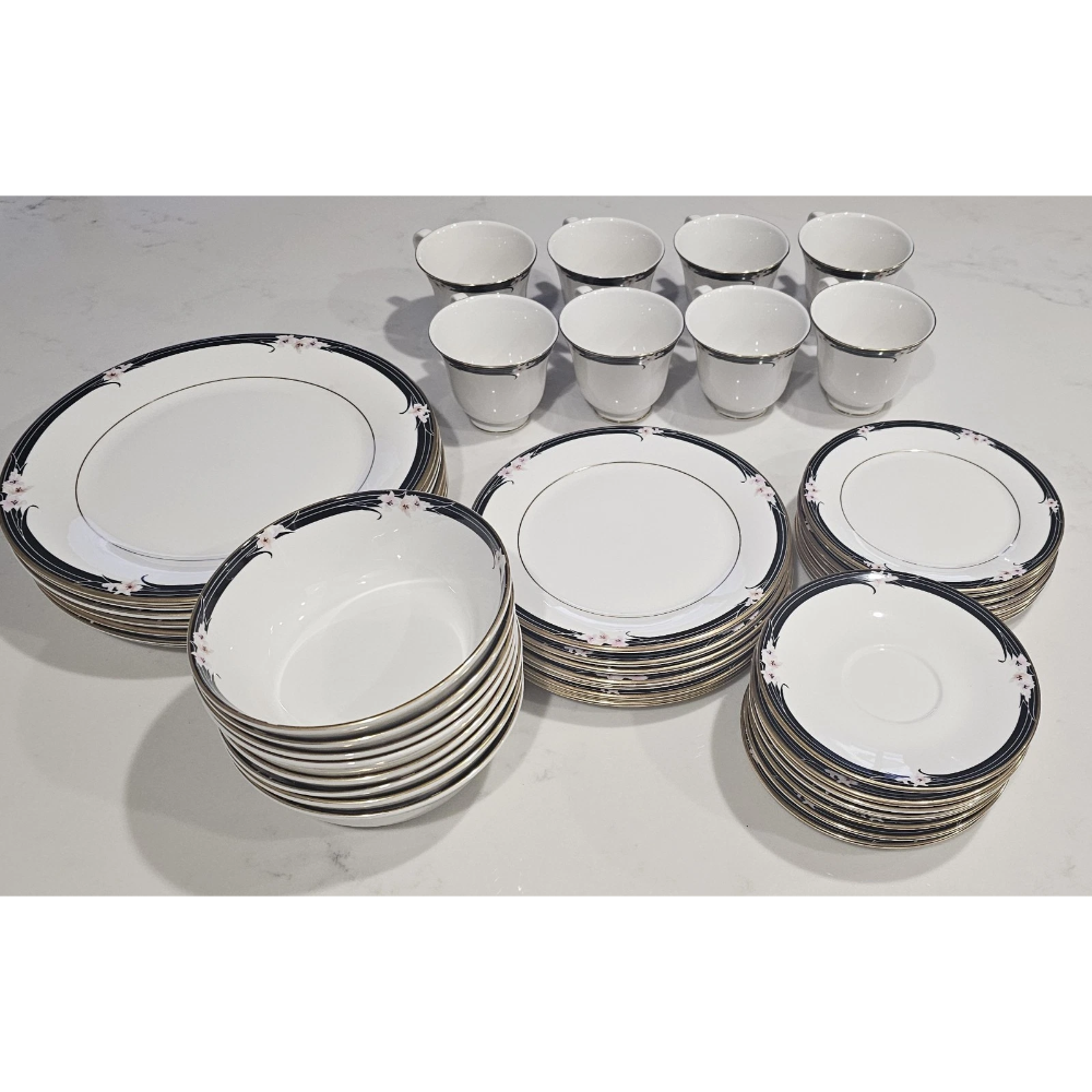 Set of ceramic dinnerware with black rim design