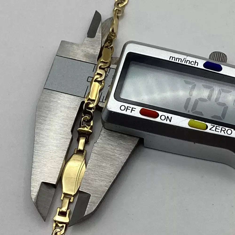 Gold bracelet being measured with a digital caliper