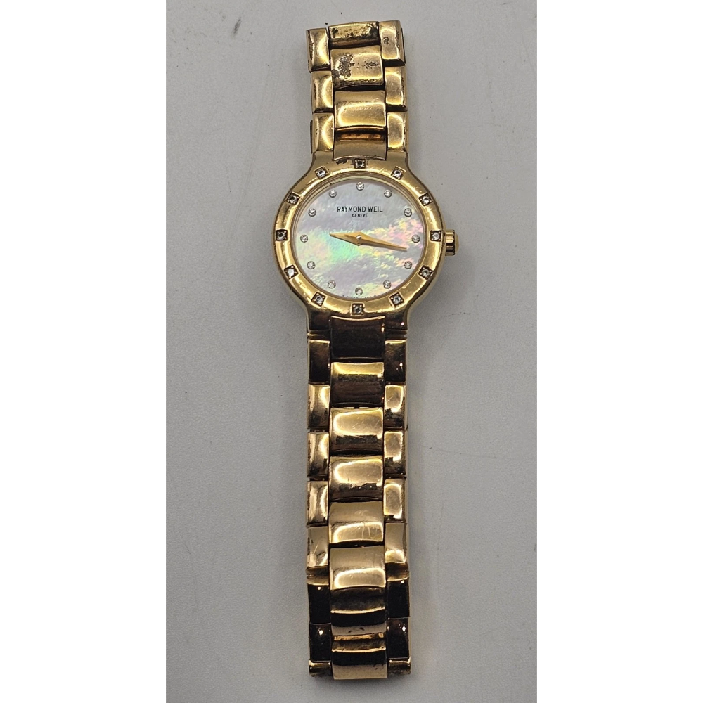 Gold wristwatch with a decorative face