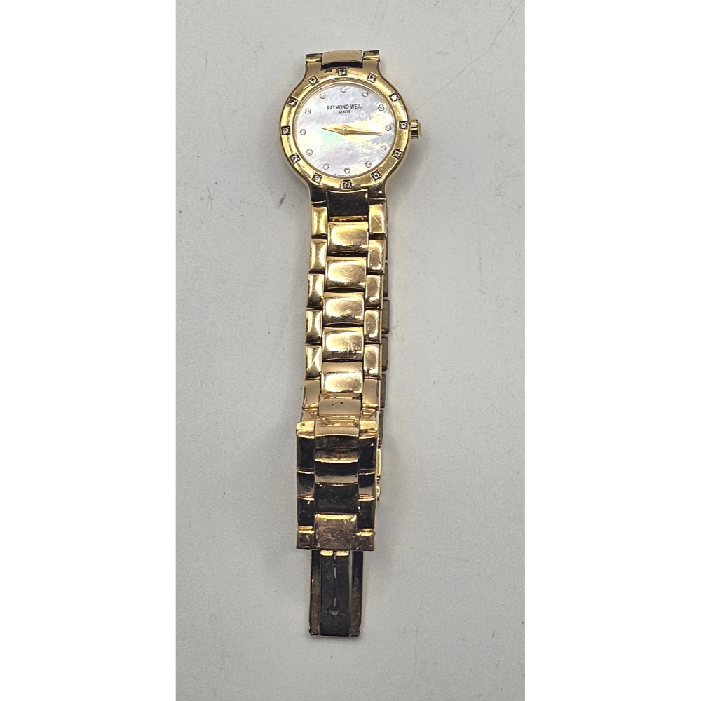 Gold watch on a light gray background