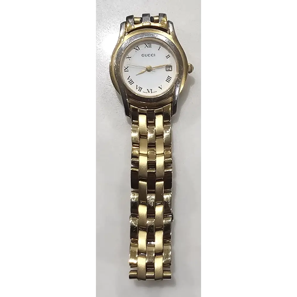 Gold and silver watch on a white background