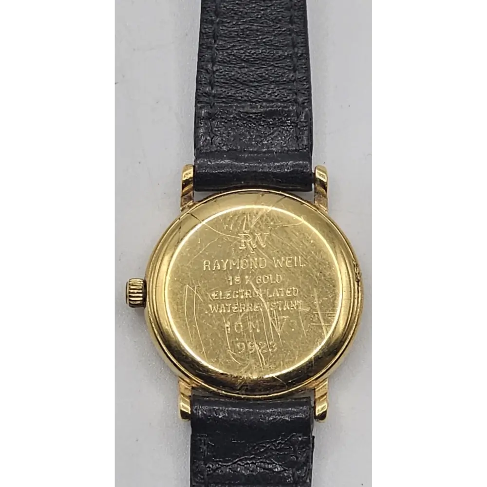 Gold watch with black leather strap